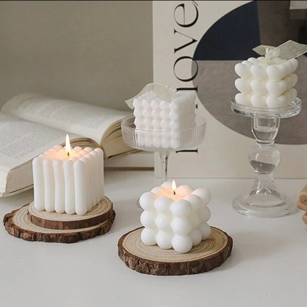 White bubble candles on wood slices