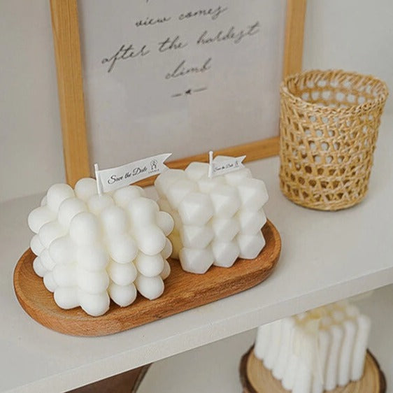 Bubble candles on a wooden tray with Save the Date flags