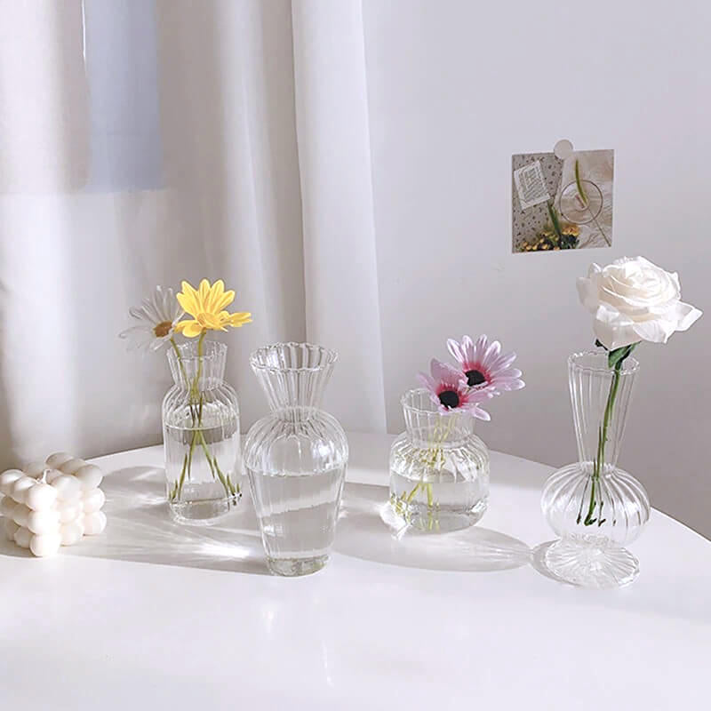 Glass flower vases with various blooms