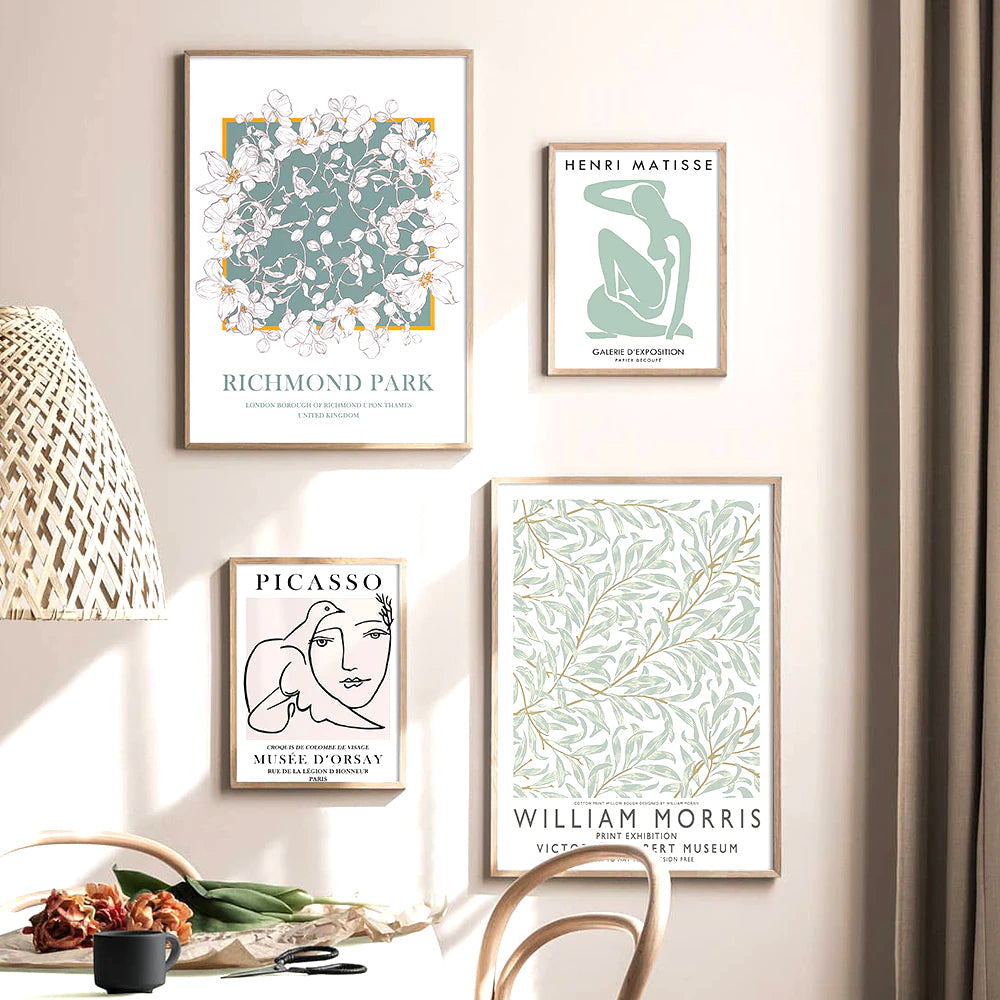Four framed art prints on a wall.