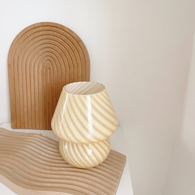 Mushroom-shaped lamp next to wooden arched and wavy decor.