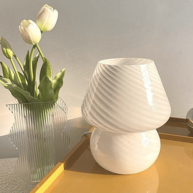 White mushroom lamp and tulips in vase.
